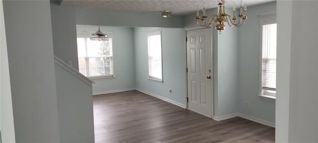 entryway with a wealth of natural light and a notable chandelier