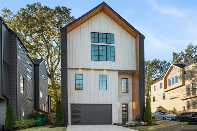 view of front facade with board and batten siding, concrete driveway, and an attached garage