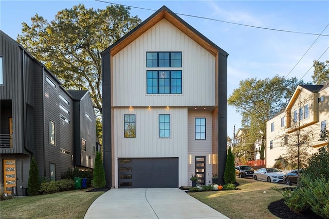 view of front of property featuring concrete driveway, an attached garage, and a front lawn