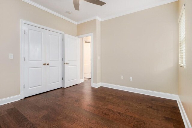 2230 Cheshire Bridge Rd NE Unit 401, Atlanta, GA 30324 - unfurnished bedroom featuring ornamental molding, dark wood-style flooring, ceiling fan, and a closet