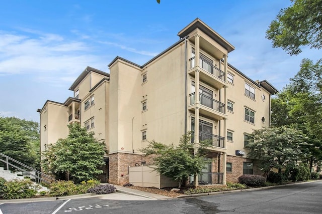 2230 Cheshire Bridge Rd NE Unit 401, Atlanta, GA 30324 - view of apartment building / complex featuring uncovered parking