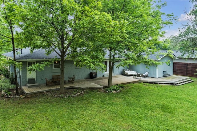 view of yard featuring a wooden deck and fence