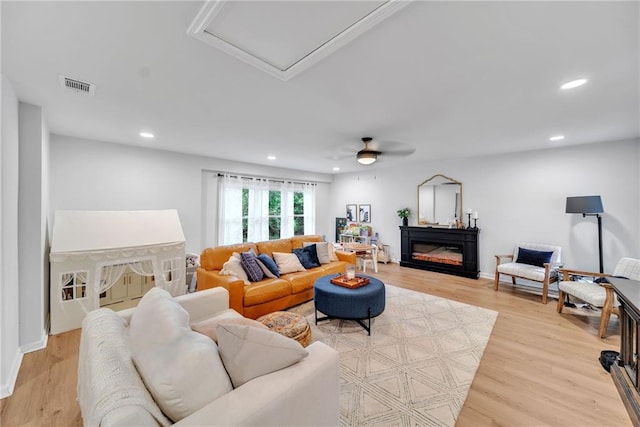 living area featuring recessed lighting, visible vents, a ceiling fan, and light wood finished floors