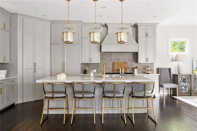 2110 Timball Rd NW, Atlanta, GA 30318 - kitchen with premium range hood, decorative backsplash, dark wood-style floors, a kitchen breakfast bar, and recessed lighting