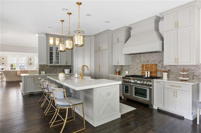 2110 Timball Rd NW, Atlanta, GA 30318 - kitchen featuring range with two ovens, custom exhaust hood, backsplash, light countertops, and glass insert cabinets