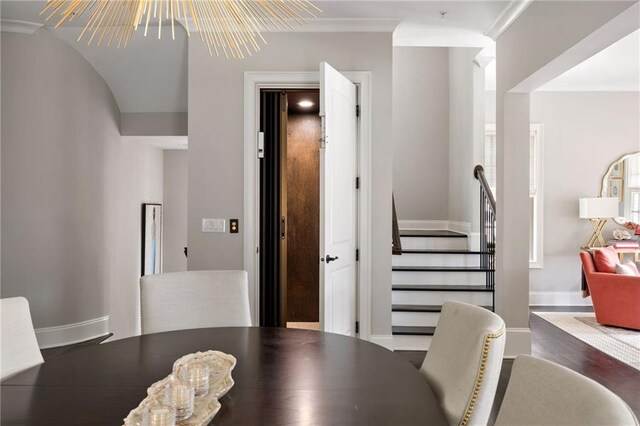 2110 Timball Rd NW, Atlanta, GA 30318 - dining area featuring a chandelier, baseboards, wood finished floors, and stairway