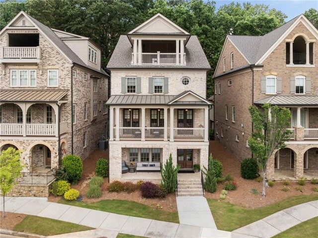 2110 Timball Rd NW, Atlanta, GA 30318 - view of front of house with a balcony, a porch, a standing seam roof, and metal roof