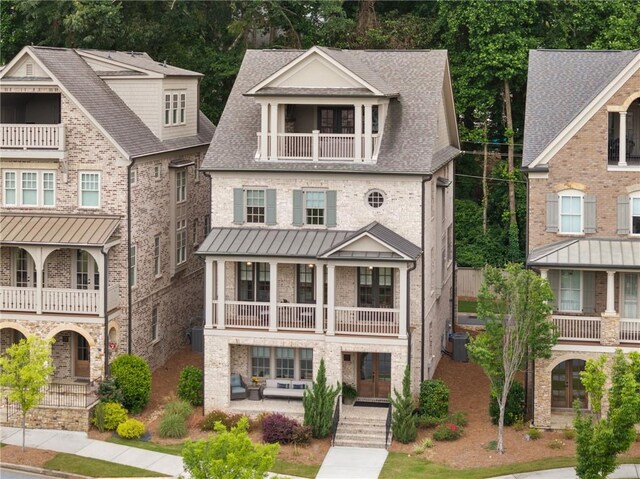 2110 Timball Rd NW, Atlanta, GA 30318 - view of front facade featuring a balcony, french doors, a standing seam roof, and brick siding