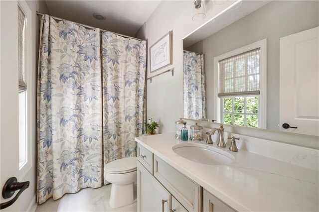 2110 Timball Rd NW, Atlanta, GA 30318 - bathroom featuring vanity, toilet, and curtained shower