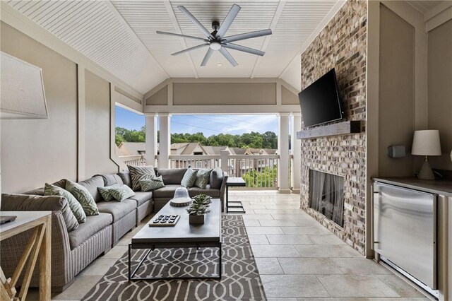 2110 Timball Rd NW, Atlanta, GA 30318 - living area with ceiling fan, vaulted ceiling, and a brick fireplace