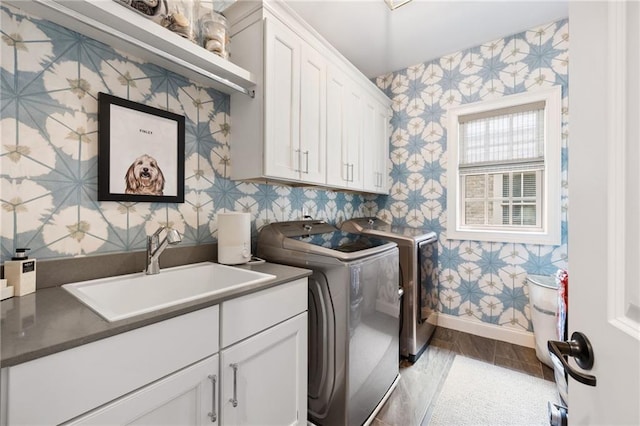 2110 Timball Rd NW, Atlanta, GA 30318 - laundry area with wallpapered walls, washing machine and clothes dryer, cabinet space, and baseboards