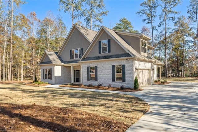 view of front facade featuring a garage, stucco siding, driveway, and brick siding