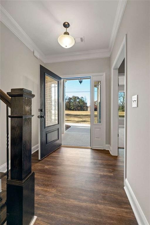 entryway featuring crown molding, baseboards, and wood finished floors