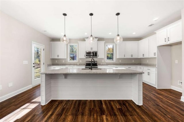 kitchen featuring white cabinetry, baseboards, appliances with stainless steel finishes, and dark wood-style floors