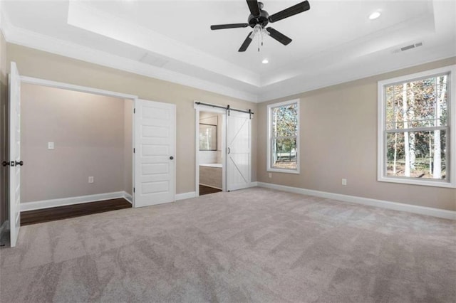 unfurnished bedroom featuring baseboards, carpet, a raised ceiling, and recessed lighting