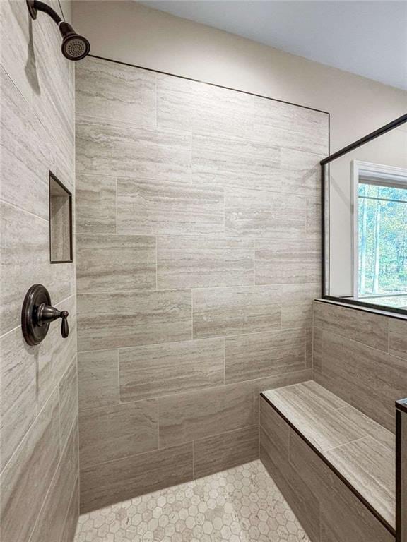 full bath featuring tiled shower