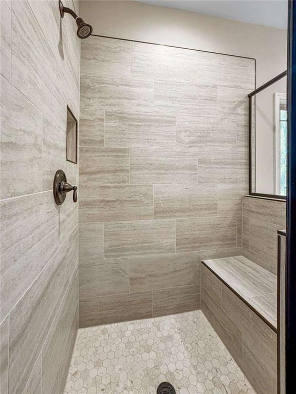 bathroom with tiled shower