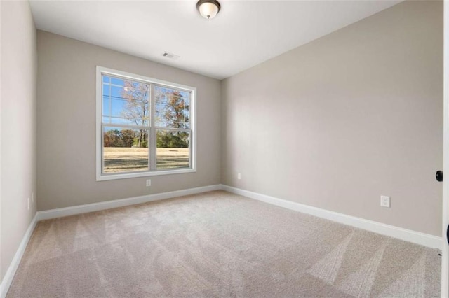 unfurnished room with baseboards, visible vents, and carpet