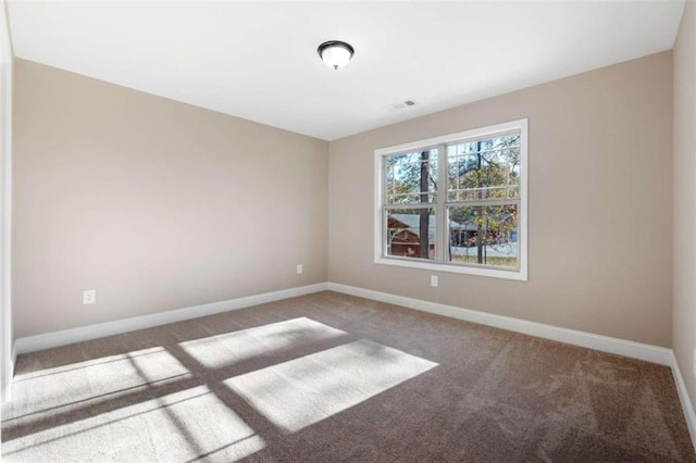 carpeted empty room with baseboards and visible vents