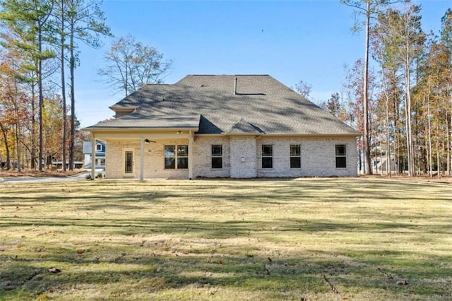 rear view of house featuring a yard