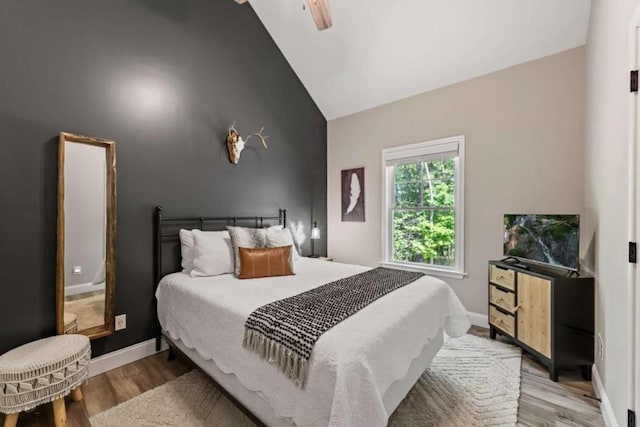 bedroom with baseboards, a ceiling fan, and wood finished floors