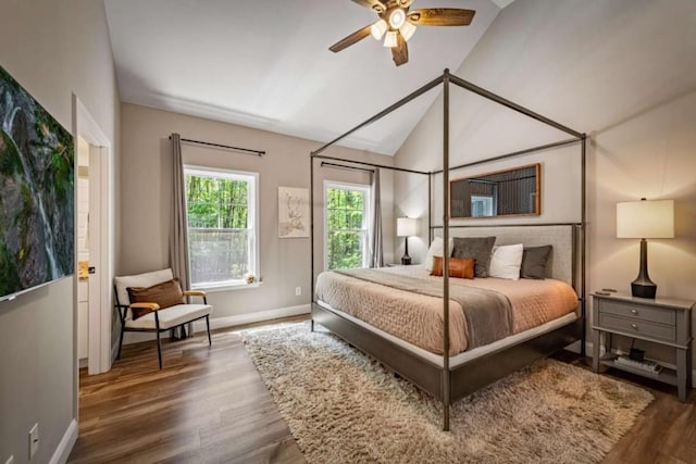 bedroom with lofted ceiling, baseboards, and wood finished floors