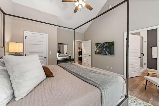 bedroom featuring a ceiling fan, baseboards, high vaulted ceiling, and wood finished floors