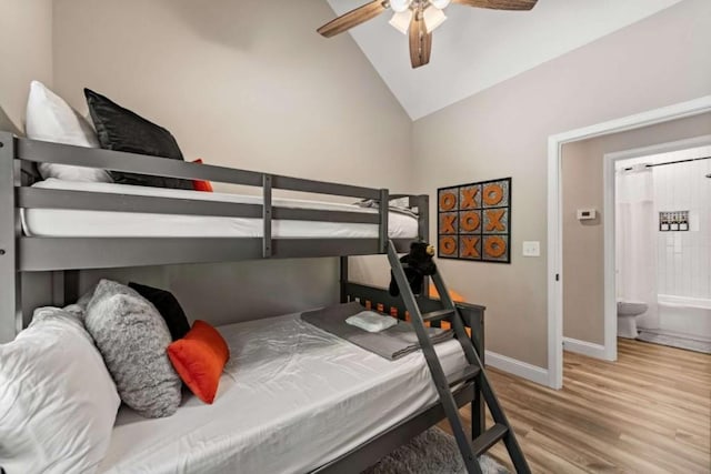 bedroom featuring vaulted ceiling, ceiling fan, baseboards, and wood finished floors