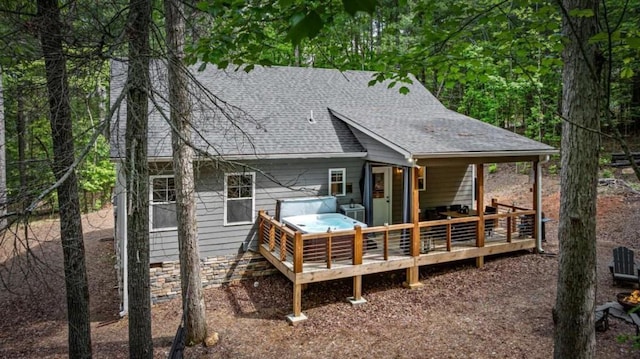 back of house with a wooden deck and a shingled roof