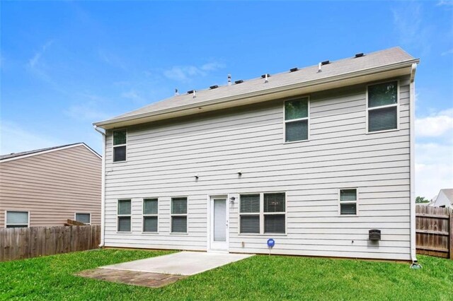 back of house featuring a yard