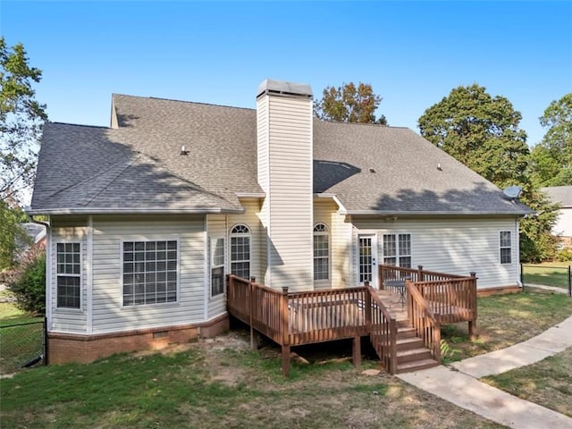 back of property with crawl space, roof with shingles, fence, and a deck