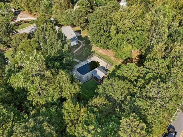 drone / aerial view featuring a view of trees