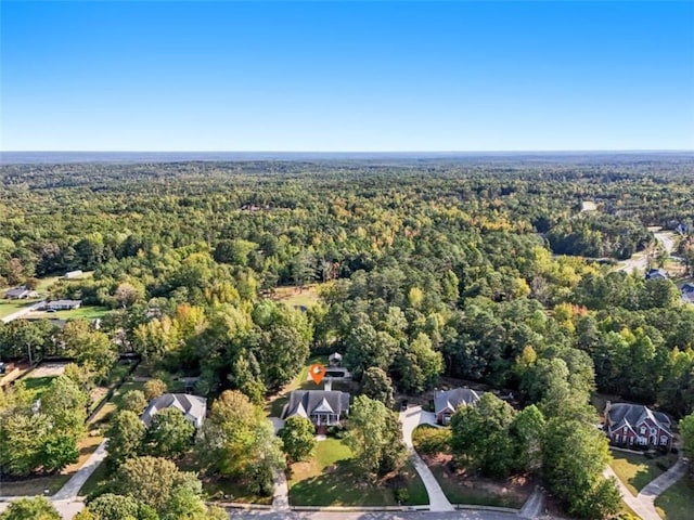 drone / aerial view with a wooded view