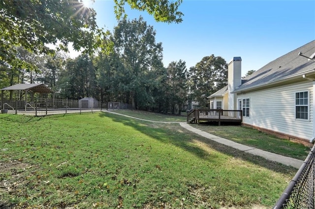 view of yard with fence and a deck