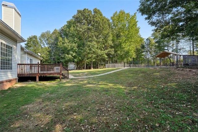 view of yard featuring a deck and fence