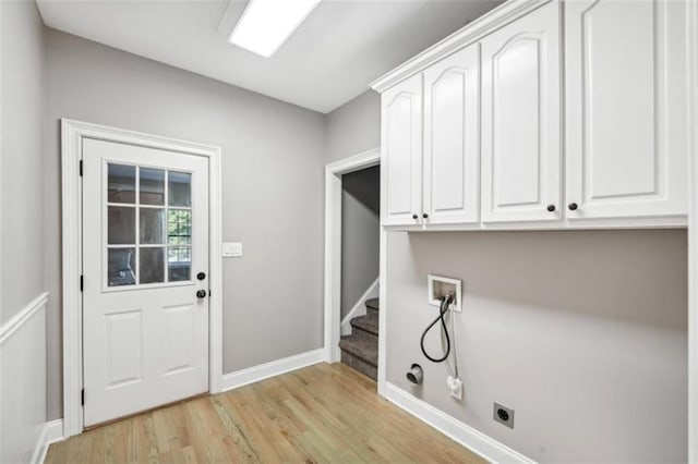 laundry room with cabinet space, light wood finished floors, hookup for a gas dryer, hookup for a washing machine, and electric dryer hookup