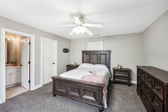 bedroom with carpet floors, ensuite bath, ceiling fan, and a sink