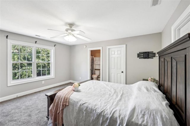 bedroom with ceiling fan, carpet floors, ensuite bath, and baseboards