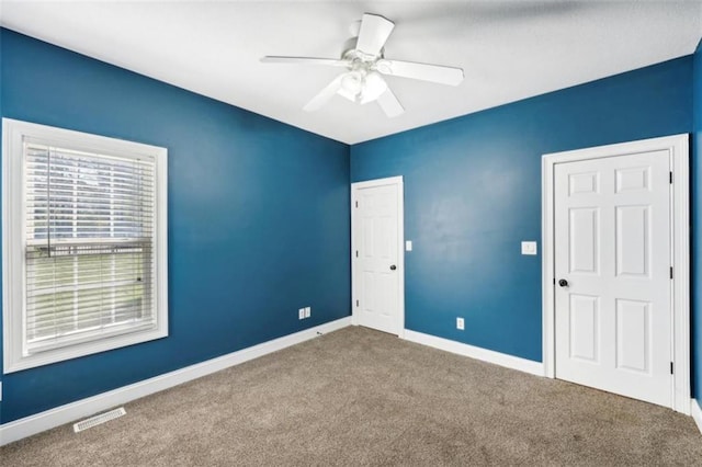 9435 Grande Dr, Winston, GA 30187 - unfurnished bedroom with baseboards, visible vents, carpet, and ceiling fan