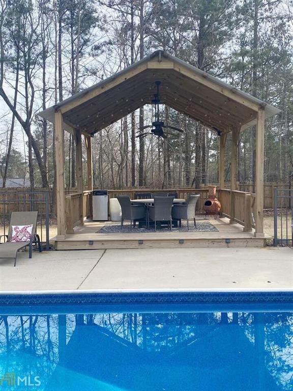 view of swimming pool featuring a fenced in pool, fence, and a deck