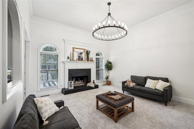 carpeted living area with a fireplace, crown molding, a notable chandelier, and baseboards