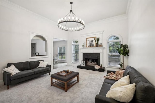 carpeted living room with ornamental molding, a chandelier, and a fireplace with raised hearth