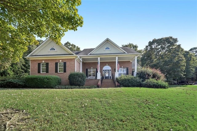 greek revival house featuring a front lawn and brick siding