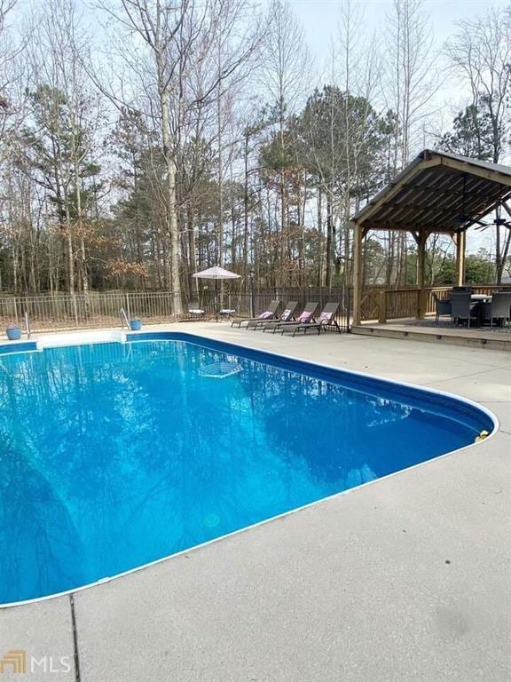 view of pool with a gazebo, a patio, fence, and a fenced in pool