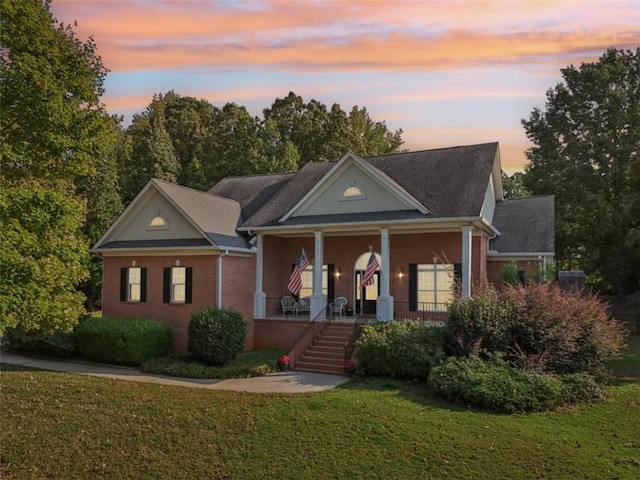 neoclassical / greek revival house with covered porch and a front yard