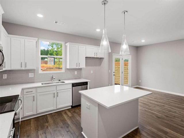 kitchen featuring dishwasher, range, a kitchen island, dark hardwood / wood-style flooring, and white cabinetry