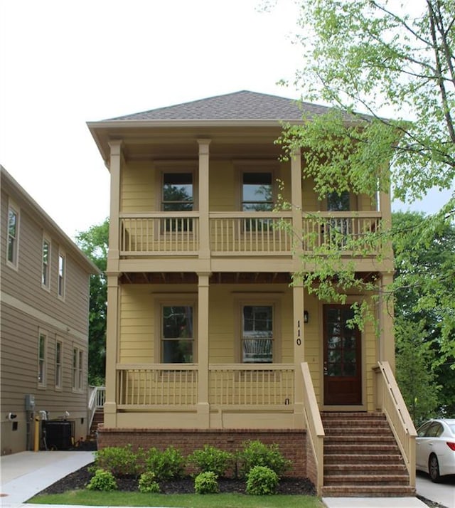 110 Hogue St, Atlanta, GA 30312 - view of front of house featuring a balcony, covered porch, central AC unit, and stairs