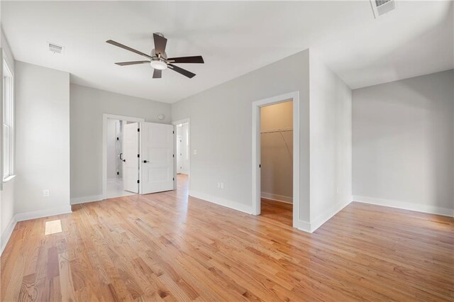 110 Hogue St, Atlanta, GA 30312 - unfurnished bedroom with light wood finished floors, baseboards, a spacious closet, and a closet