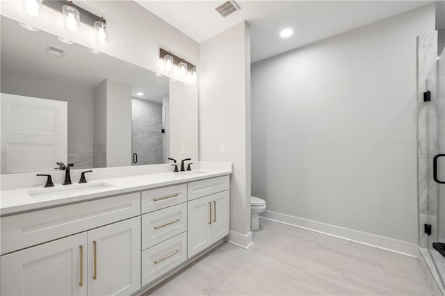 110 Hogue St, Atlanta, GA 30312 - bathroom featuring double vanity, toilet, a shower stall, baseboards, and recessed lighting