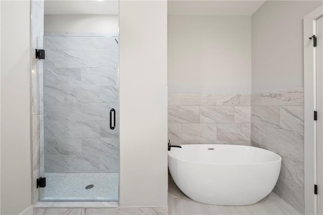 110 Hogue St, Atlanta, GA 30312 - bathroom with a freestanding bath, a stall shower, tile walls, and wainscoting